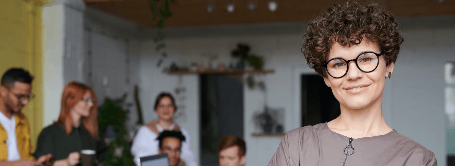 Woman with glasses in front of a group of people