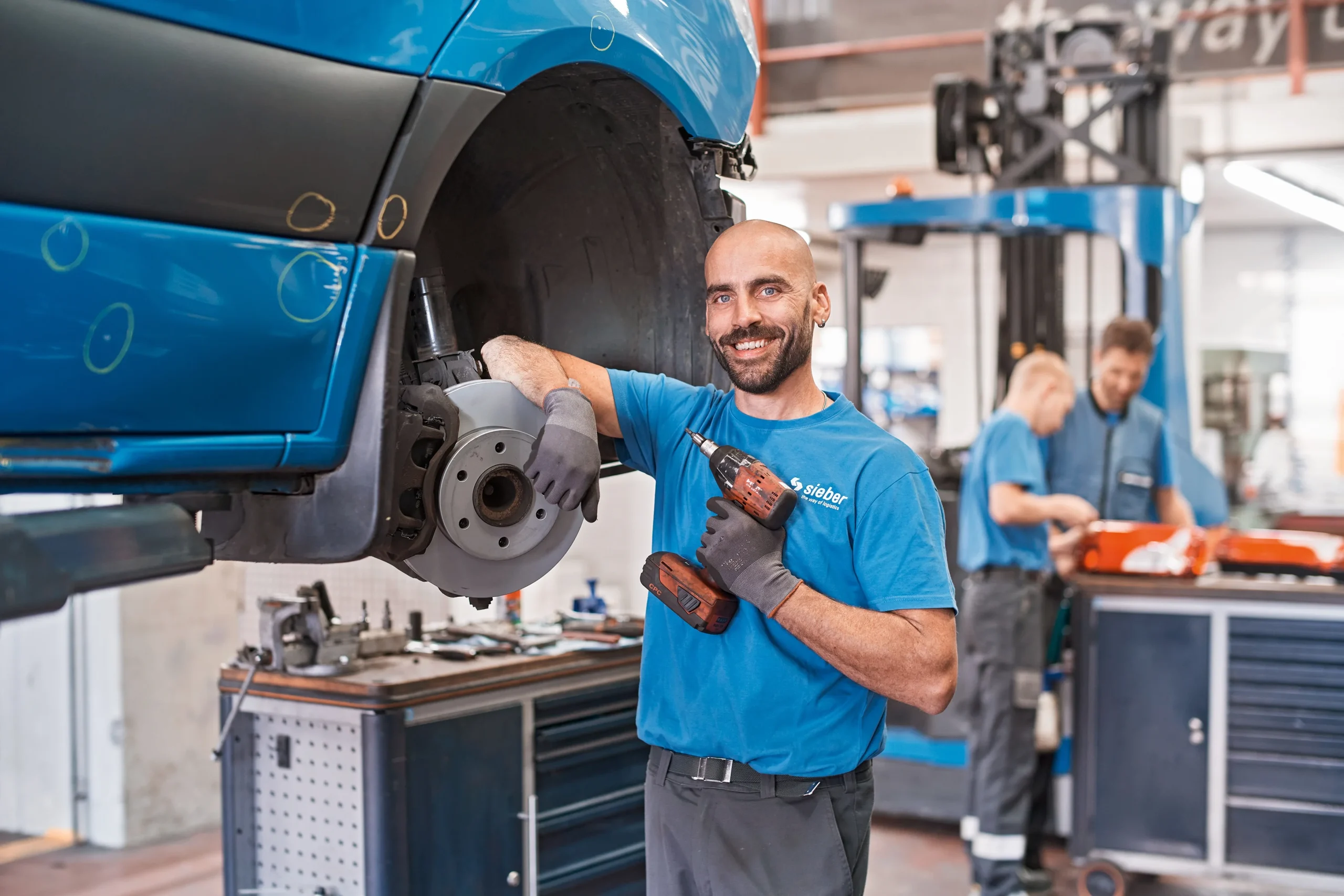 Woman with glasses in front of a group of people